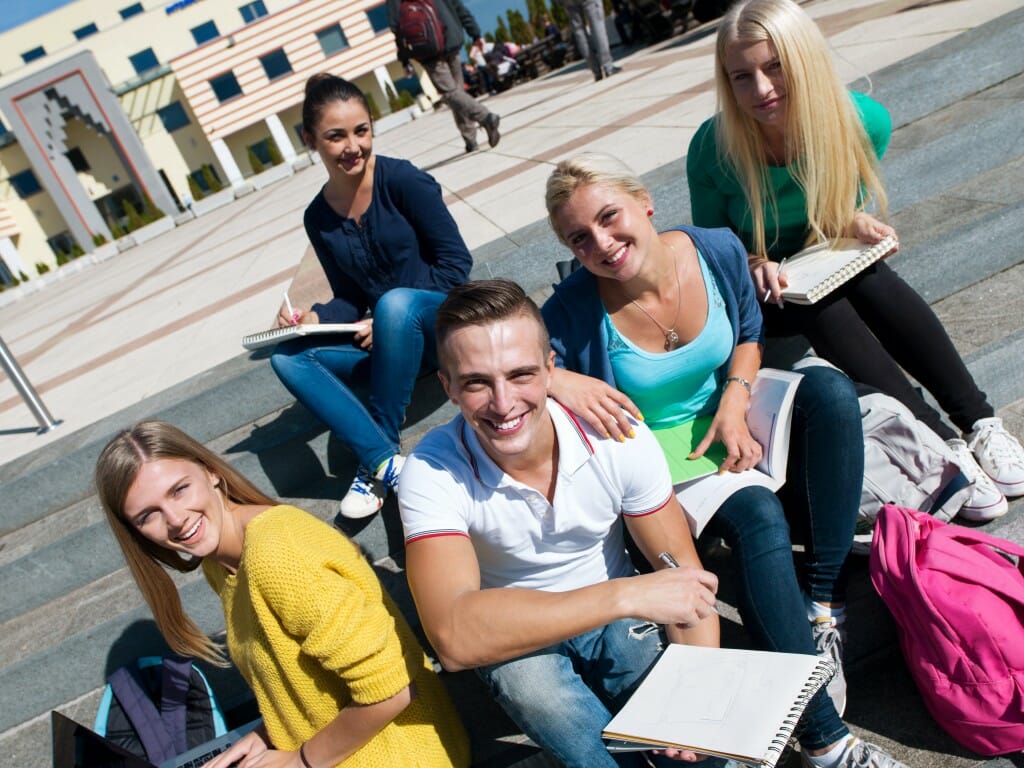 students outside sitting on steps